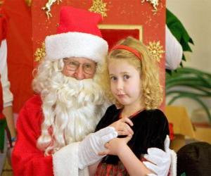 Girl talking to Santa Claus sitting on his lap puzzle