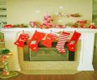 Fireplace in Christmas with the hung socks and with Christmas decorations