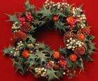 Christmas wreath formed by holly leaves and varied fruits